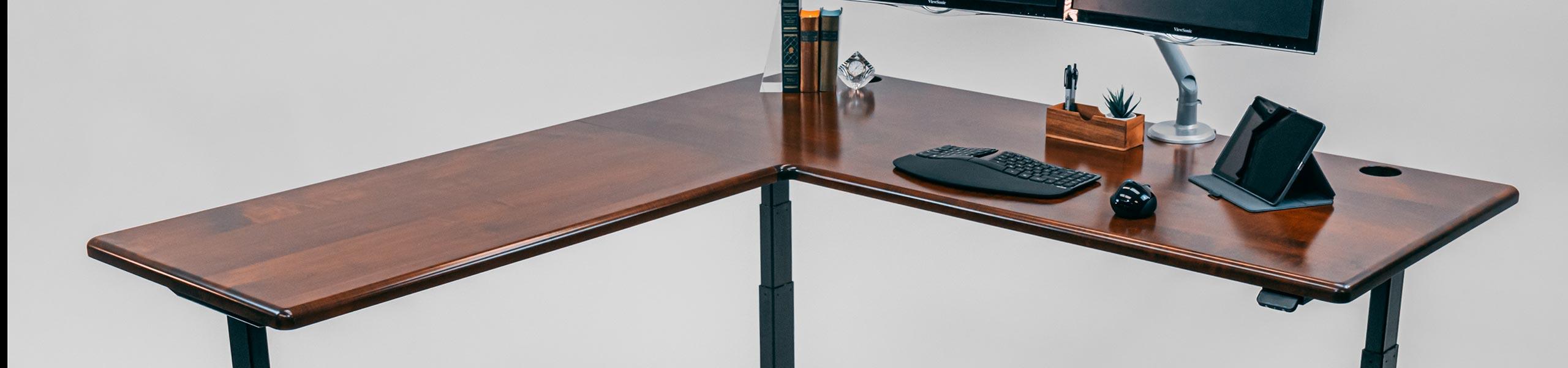 Lander Standing L-Desk with Leather Maple Solid Wood Top on Black base.