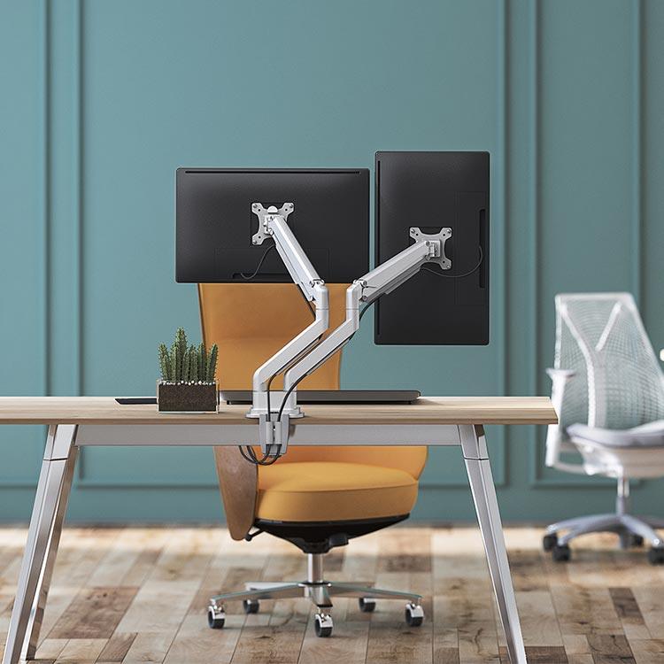 The Echo Dual Monitor Arm, shown in silver, holding screens in both portrait and landscape.