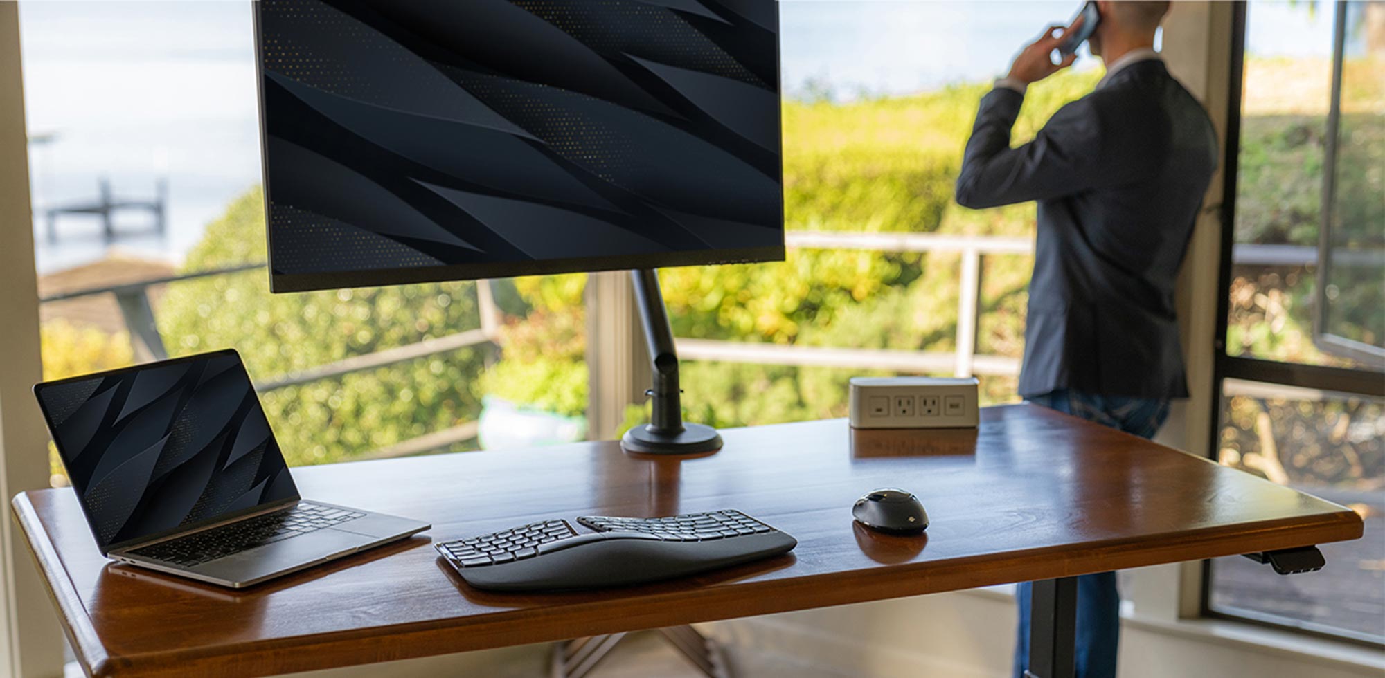 Solid Wood Lander Desk with Leather Maple Desktop on Black base. Featuring Tempo Single-Screen Monitor Arm (Black), and Dyna Grommet-Mounted Power Block with Qi Wireless Power.