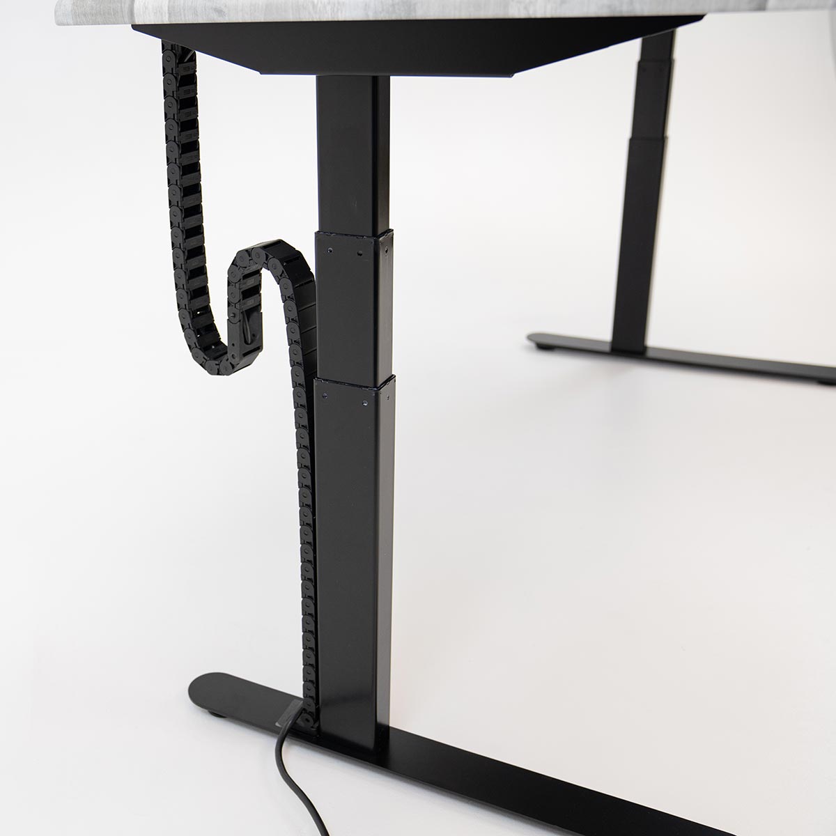 Desk at standing height with Tucker Cable Chain installed.