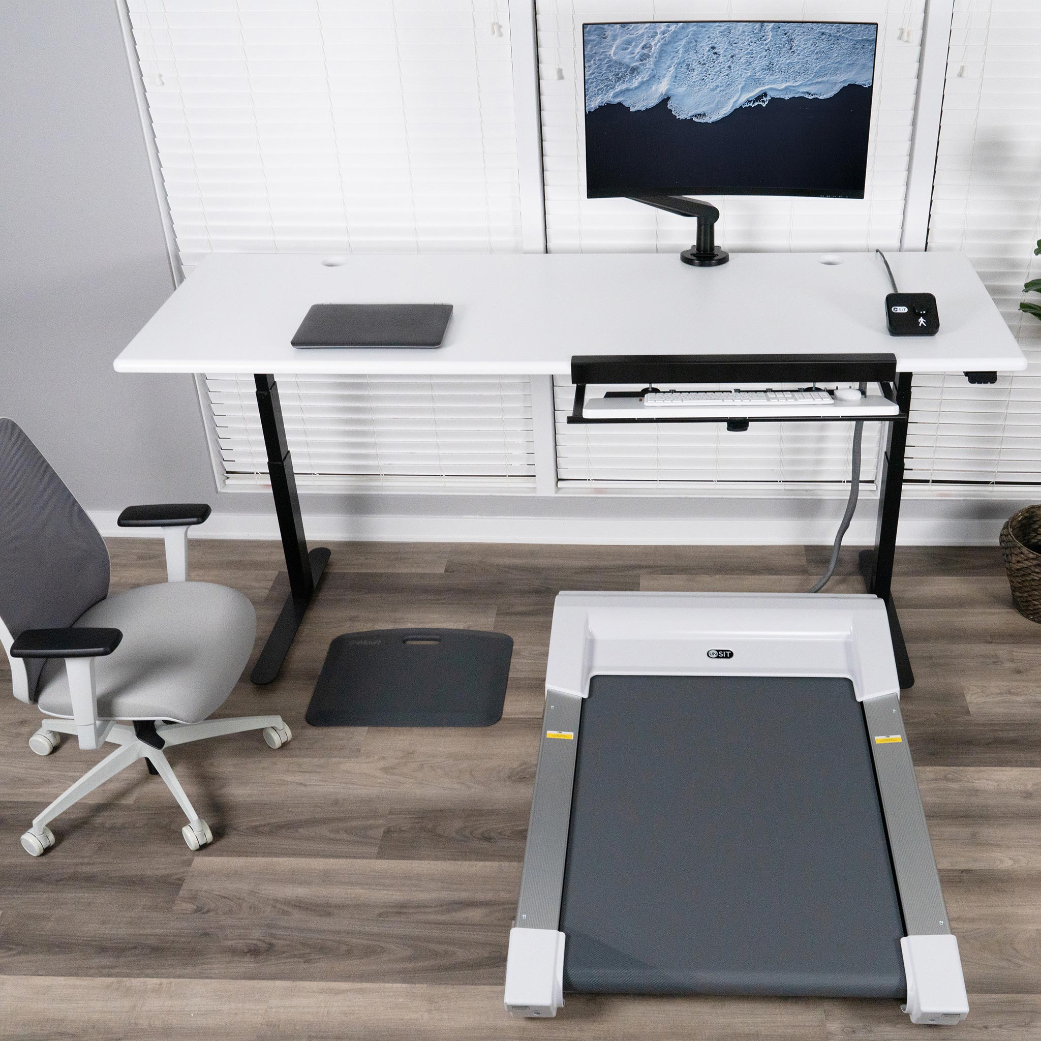 Lander Unsit Treadmill Desk with SteadyType Exo, Designer White Top and Black Base, Neemo Task Chair also shown.